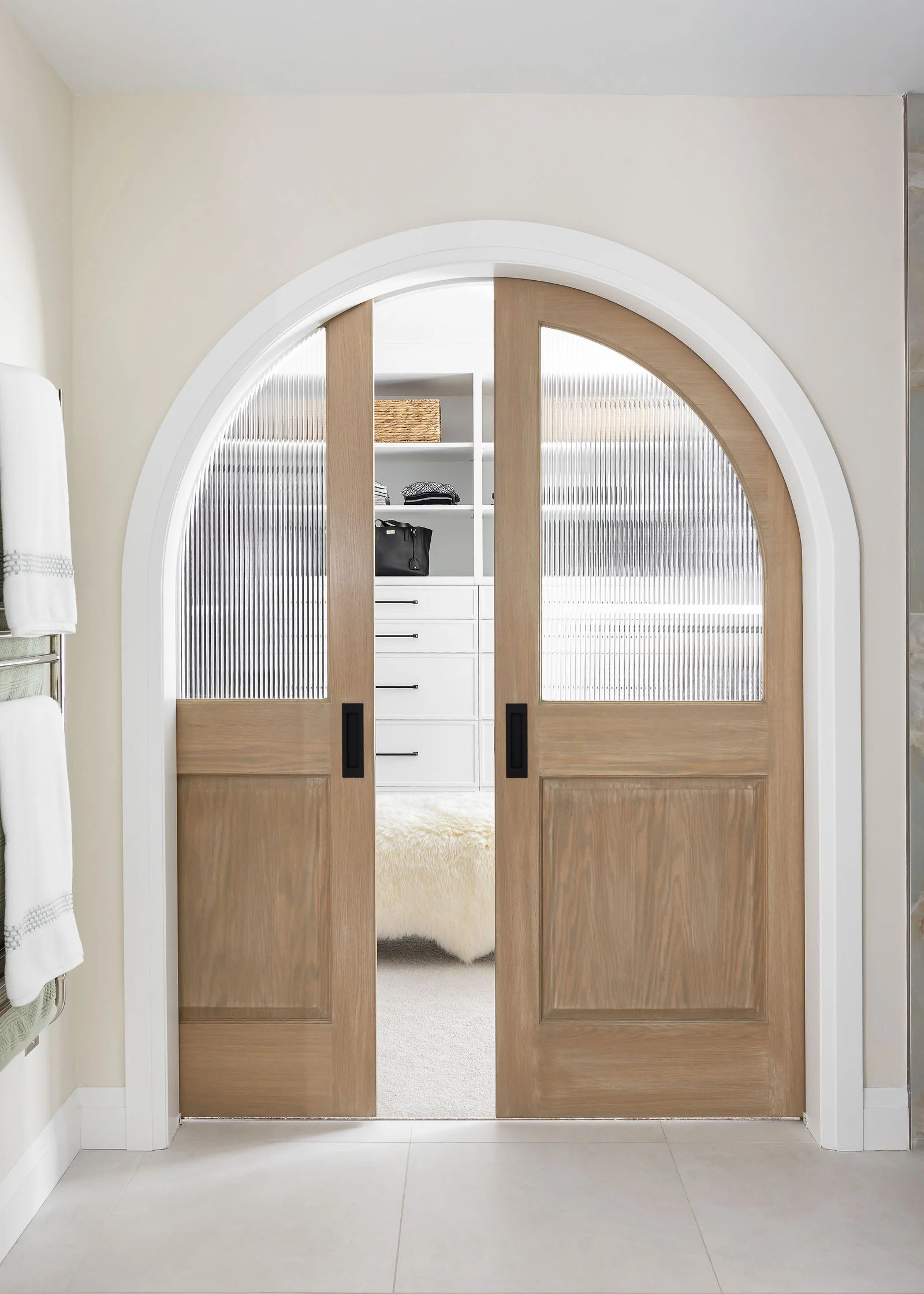 An arched doorway with oak doors
