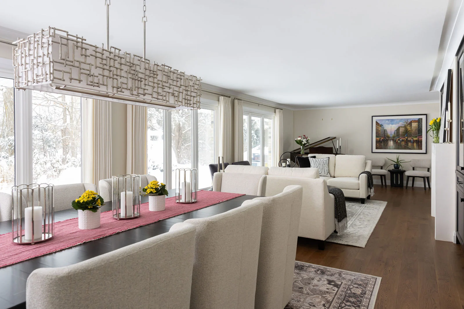 A dining area beside floor-to-ceiling windows