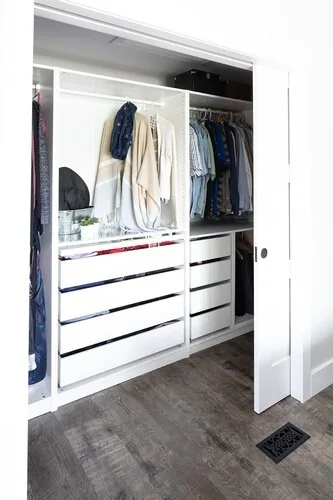 Fitted closet with open storage and white drawers at Caldwell II