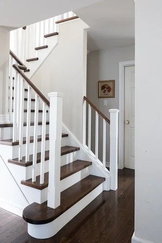 Staircase with wood treads, white risers and white balusters at Caldwell II