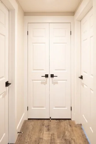 White interior doors and trim at the end of a hallway at Caldwell II
