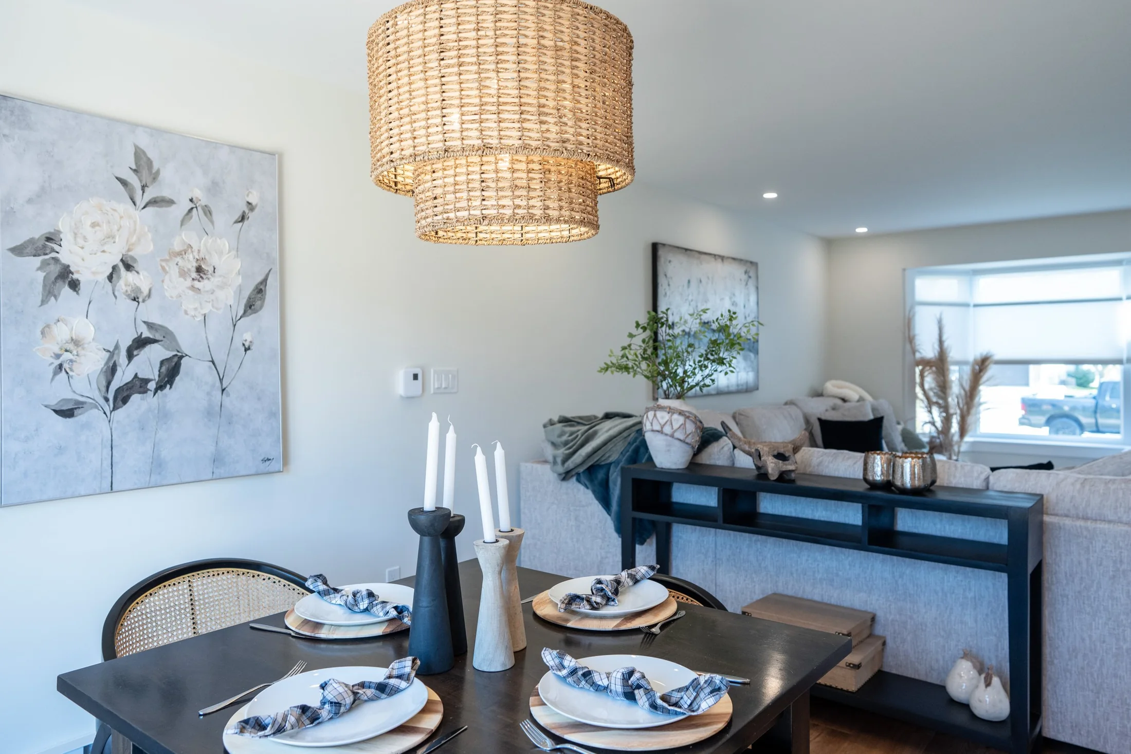 Dining area with a woven pendant light beside the living room at Joseph I