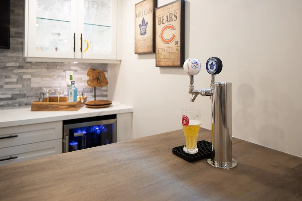 Bar counter with twin taps and glass-front wall cabinets at Kingsridge I