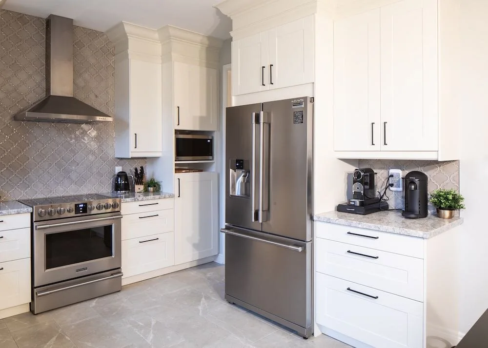 Kitchen storage surrounding a stainless steel refrigerator at Mariposa I