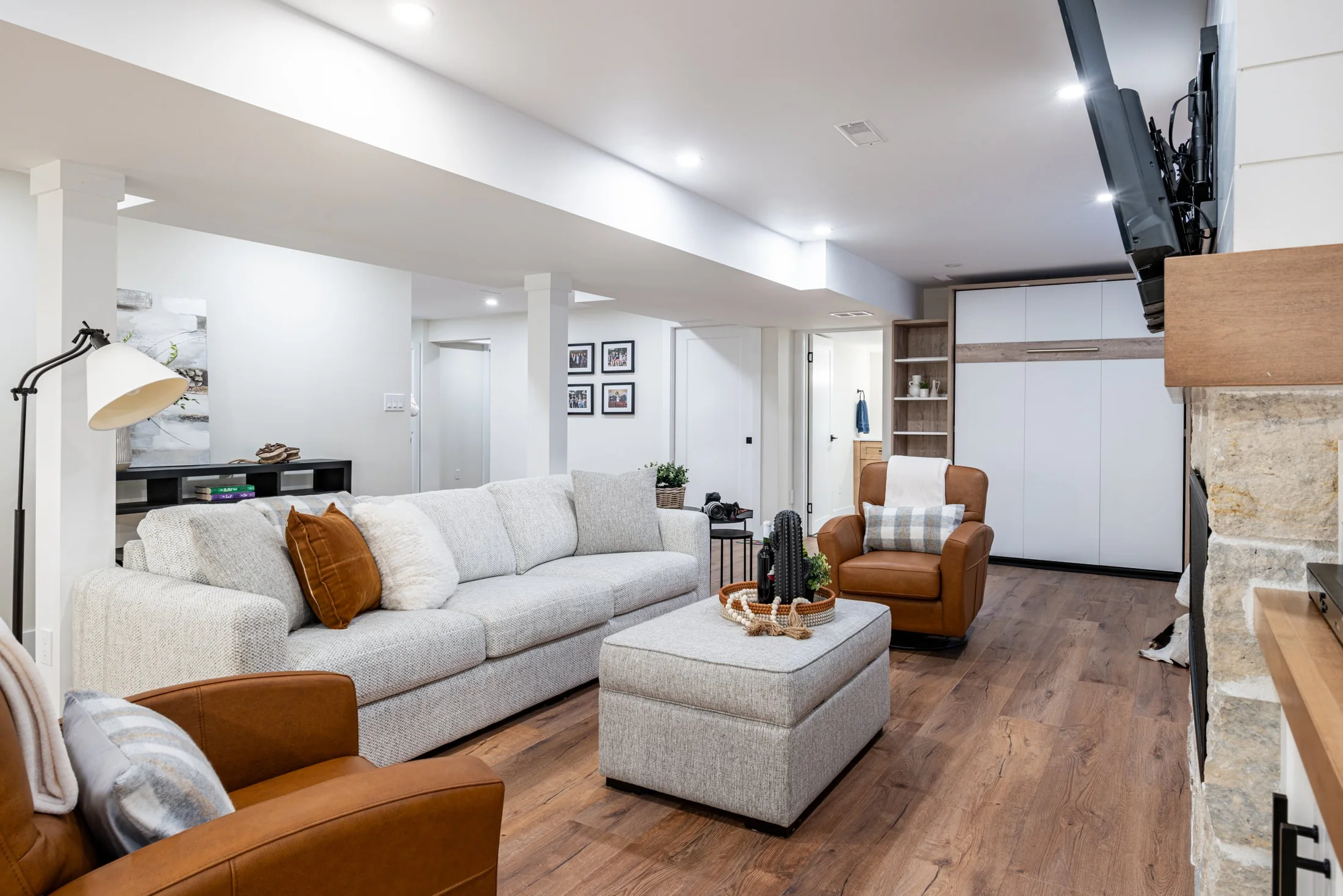 Basement sofa and armchair beside built-in shelving at Mill Creek I
