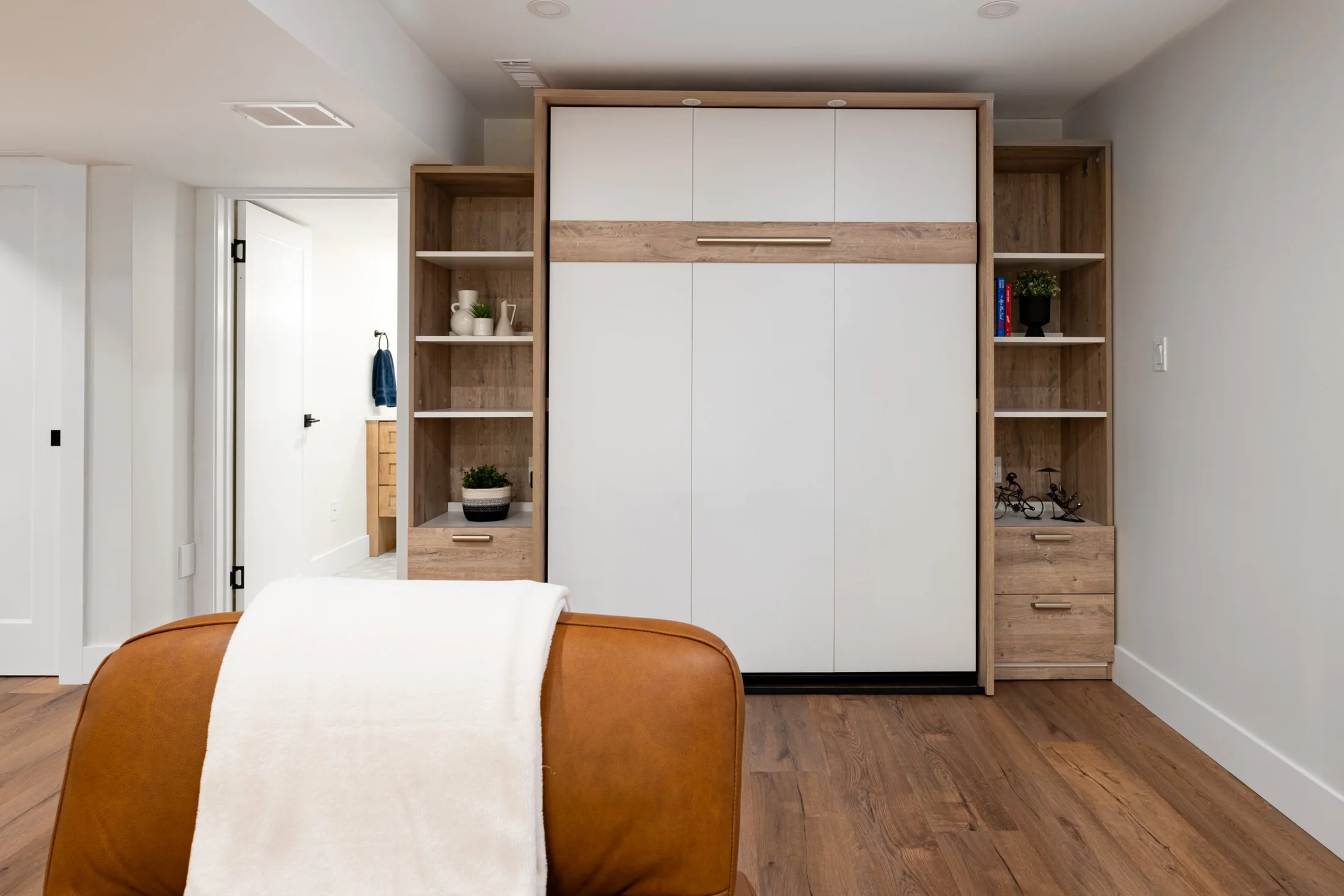 White cabinet doors framed by wood shelving in the basement at Mill Creek I