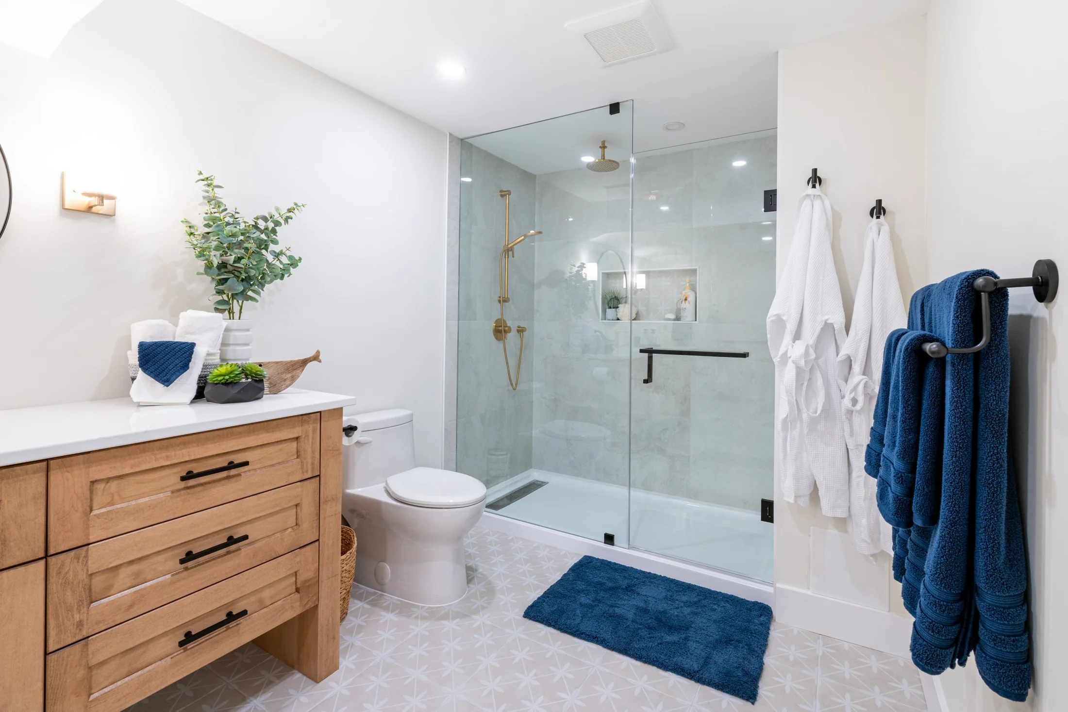 Bathroom with a wood vanity and a glass shower enclosure at Mill Creek I