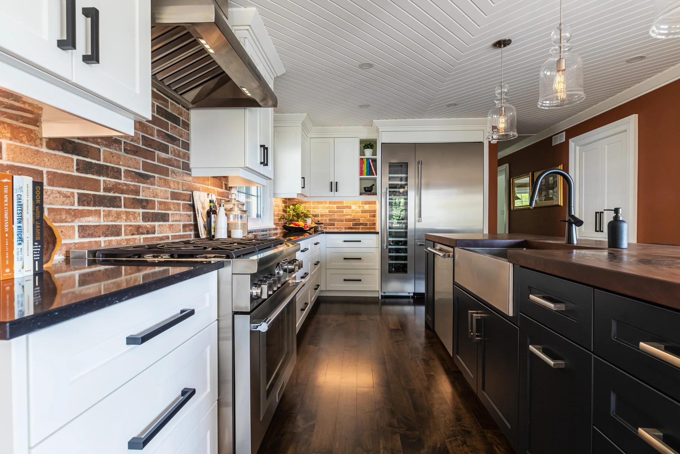 Kitchen with a brick backsplash and stainless steel range hood at South Rankin I