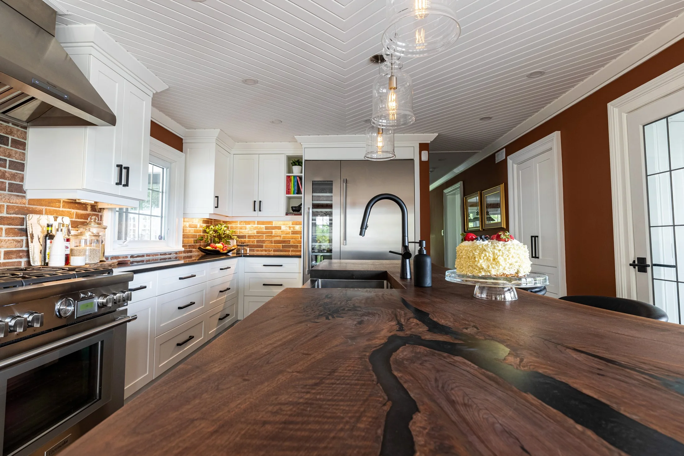 Wood island counter with a dark inset and a black kitchen faucet at South Rankin I