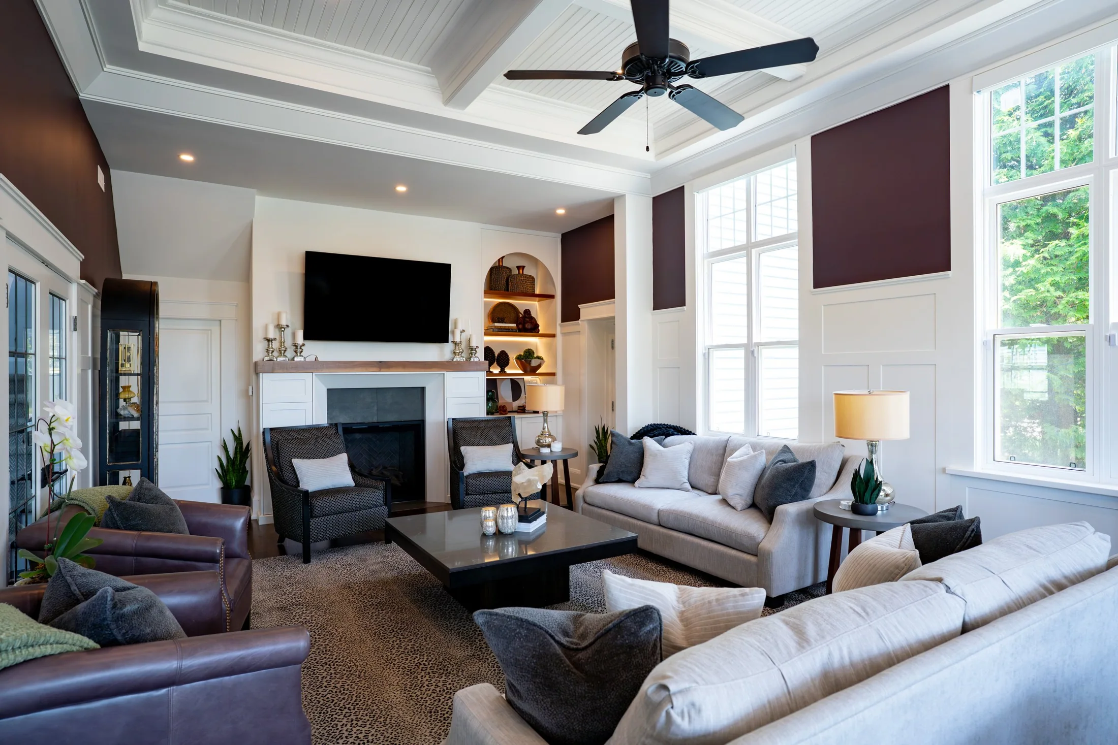 Living room with a fireplace, tall windows, pale sofas and a panelled ceiling at South Rankin II