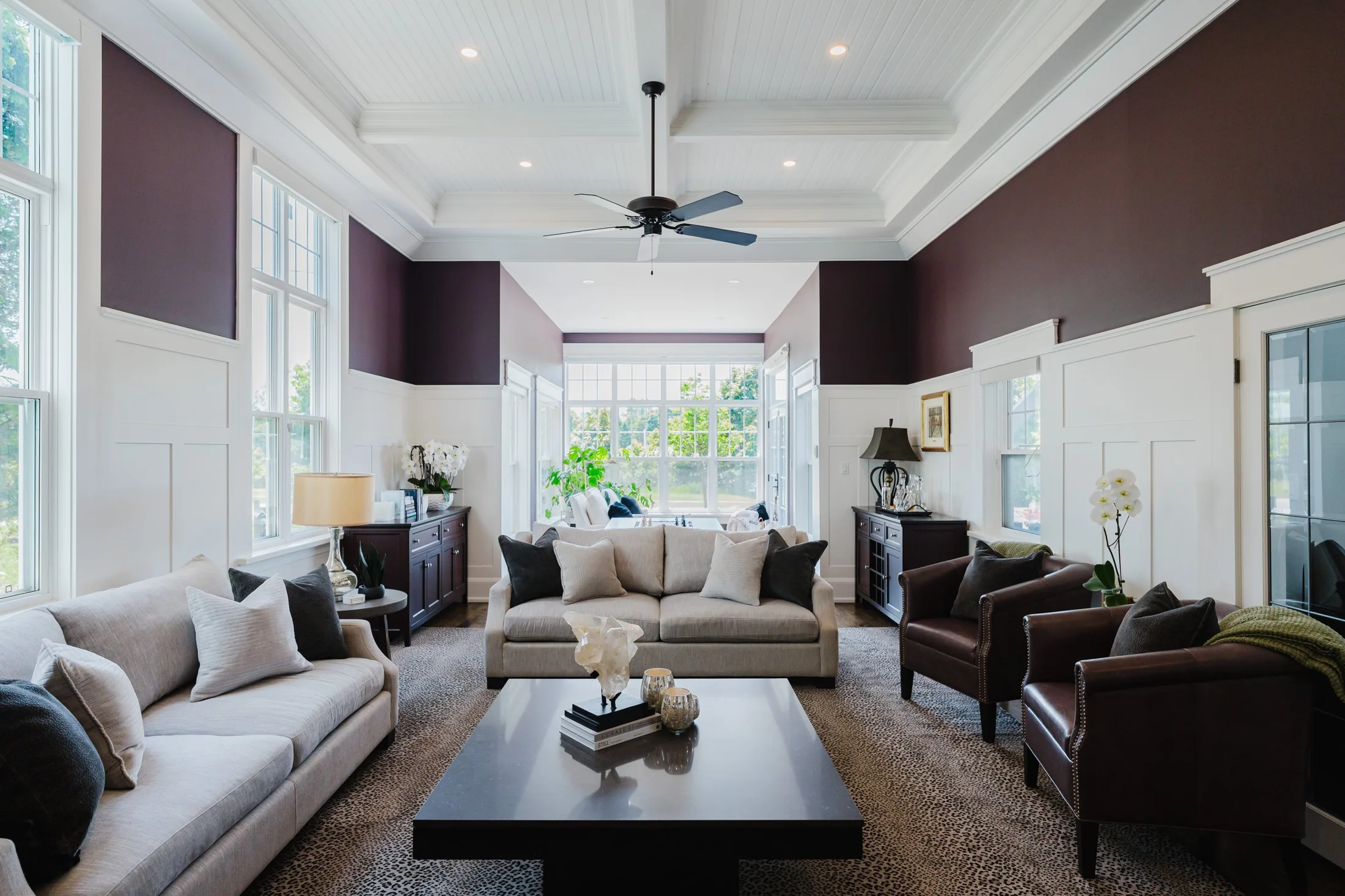 Living room seating arranged beneath a recessed ceiling and ceiling fan at South Rankin II