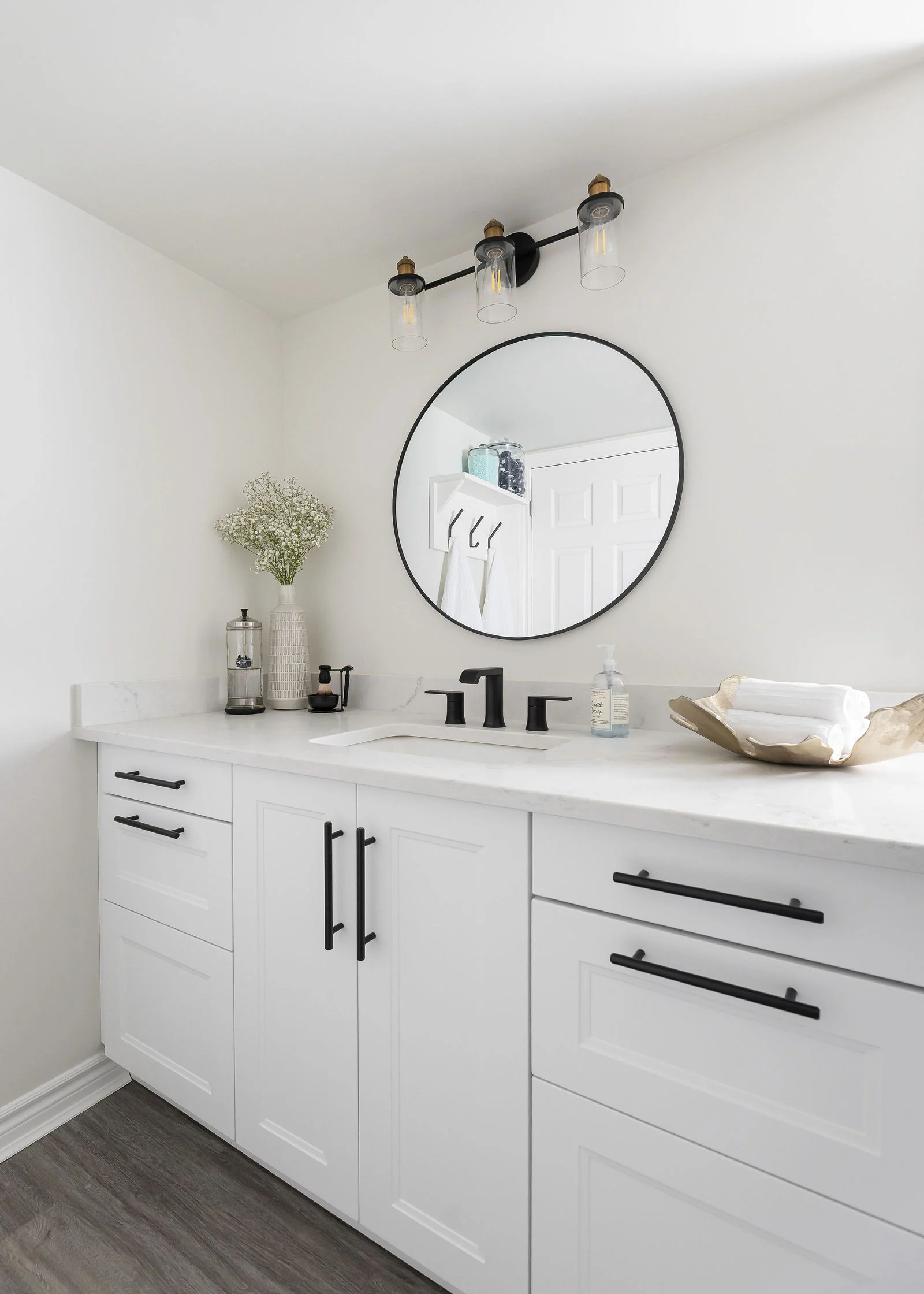 Bathroom vanity with a round mirror